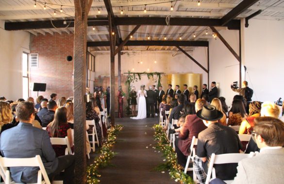 wedding ceremony in a warehouse with wooden floors